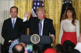  ?? MARK WILSON, GETTY IMAGES ?? Donald Trump is flanked by Labour Secretary Alex Acosta and first lady Melania Trump as he speaks to guests gathered in the White House on Friday to celebrate Hispanic Heritage Month.