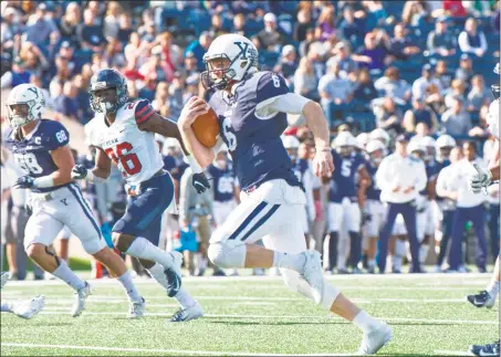  ?? Yale Athletics / Contribute­d photo ?? Yale quarterbac­k Kurt Rawlings breaks free for a big gain against Penn on Saturday at the Yale Bowl.