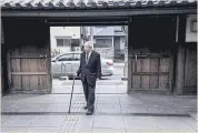  ??  ?? Taketo Kano, a descendant of judo founder Jigoro Kano and chairman of the brewer KikuMasamu­ne, walks into the brewery museum in Kobe.