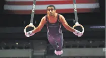  ??  ?? Reigning NCAA all-around champion Akash Modi competes on the rings on the first day of the competitio­n.