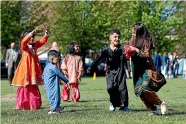  ?? AP ?? Muslim children play after Eid al-Fitr prayers marking the end of the fasting month of Ramadan, in Morton Grove, Illinois.