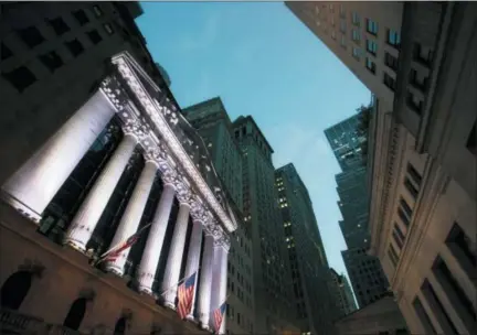  ?? MARK LENNIHAN — THE ASSOCIATED PRESS FILE ?? American flags fly in front of the New York Stock Exchange.