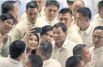  ?? NOEL CELIS/AFP/GETTY IMAGES ?? Philippine President Rodrigo Duterte poses for a selfie after delivering his state of the nation address in Manila on Monday.