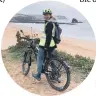  ??  ?? E-biking with views of Thurleston­e Rock, an arch shaped formation off the coast
of South Devon.