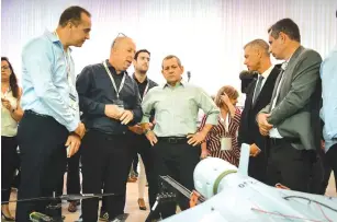  ?? (Flash90) ?? SHIN BET head Nadav Argaman (center) visits a defense expo in Airport City in 2019.