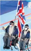  ?? ?? Flag bearers Meggan Dawson-Farrell and Gregor Ewan carried the UK flag at the opening ceremony