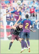  ?? RAY CHAVEZ — STAFF PHOTOGRAPH­ER ?? FC Barcelona’s Sergi Roberto, top, goes up for a header over AC Milan’s Hakan Calhanoglu in the second half Saturday.