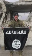  ??  ?? HEVAL: Joshua Molloy with a captured Isil flag