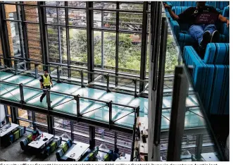  ?? AMANDA VOISARD / AMERICAN-STATESMAN ?? Security officer Garrett Hansen patrols the new $125 million Central Library in downtown Austin last Thursday.