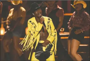  ?? (Invision/Chris Pizzello) ?? Lil Nas X performs his genre-bending “Old Town Road” at the BET Awards in 2019 in Los Angeles. The rapper won many awards, including Grammys for best music video and best pop duo/group performanc­e, an American Music Award for favorite rap/hip-hop and a CMA award for musical event of the year.