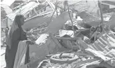  ?? SAID YUSUFWARSA­ME, EPA ?? A woman looks over rubble from a May 17 explosion inMogadish­u, Somalia.