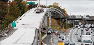  ?? PHOTO BY PHIL SKINNER ?? Workers prepare part of a bridge near Delk Road during Northwest Corridor Express Lanes constructi­on. The road’s resemblanc­e to a roller coaster got one commuter thinking.