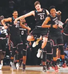  ??  ?? South Carolina players celebrate their 70-50 victory over Baylor in an East Regional semifinal game Friday. Julio Cortez, The Associated Press