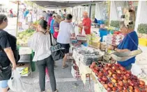  ?? JERRY FALLSTROM/STAFF ?? Fruits and vegetables are popular items at the Downtown Clermont Farmers Market held on Sundays along Montrose Street.