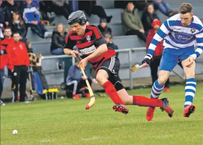  ?? Photograph: Kevin McGlynn. ?? Opening goal scorer Andrew ‘Papa’ MacCuish is stopped in his tracks by Newtonmore’s Andy MacKintosh. Champions Newtonmore suffered their first league defeat in two years, going down 2-1 to Oban Camanachd.