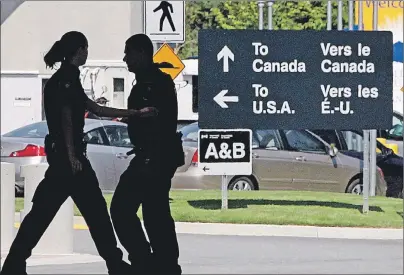  ?? CP PHOTO ?? Canadian border guards are silhouette­d as they replace each other at an inspection booth at the Douglas border crossing on the Canada-U.S. border in Surrey, B.C., in this 2009 file photo. Fewer Canadians are being turned away at the U.S. land border in...