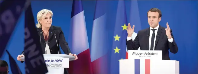  ??  ?? A COMBINATIO­N photo showing French presidenti­al election candidates Marine Le Pen (L) of the far-right Front National party, and Emmanuel Macron (R) of the En Marche! movement, delivering speeches to their respective supporters on April 23, after the...