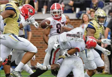  ?? HYOSUB SHIN / HYOSUB.SHIN@AJC.COM ?? Georgia running back D’Andre Swift fumbles the football during the first half of the Bulldogs’ 52-7 victory Saturday over instate rival Georgia Tech. Swift later left the game with a shoulder injury.