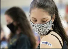  ?? PHIL LONG — THE ASSOCIATED PRESS FILE ?? Kent State University student Regan Raeth, of Hudson looks at her vaccinatio­n bandage as she waits after her shot in Kent in April. On Wednesday, May 12, Gov. Mike DeWine announced the end of the state’s mask mandate as new COVID-19cases decrease and more Ohioans get vaccinated.