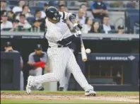  ?? The Associated Press ?? GRAND SLAM: New York Yankees’ Gleyber Torres hits a grand slam Friday during the first inning of the team’s baseball game against the Boston Red Sox in New York.