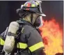  ?? Christian Abraham / Hearst Connecticu­t Media ?? Fair Haven firefighte­r Jonathan Clarke stands by with a hose to put out flames from a fire inside a simulated living room with a Christmas tree during a demonstrat­ion held at the New Haven Fire Training Academy in New Haven on Nov. 27.