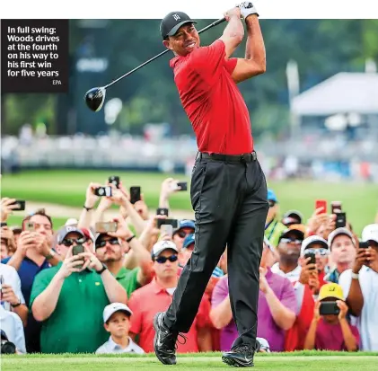  ?? EPA ?? In full swing: Woods drives at the fourth on his way to his first win for five years