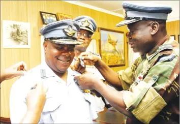  ?? — Picture by John Manzongo ?? Air Force of Zimbabwe Commander Air Marshal Perrance Shiri (right) bestows Air Commodore rank on Antony Viano at Air Force Headquarte­rs in Harare yesterday.