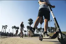  ?? GETTY IMAGES ?? People ride Bird electric scooters along Venice Beach in Los Angeles, Calif. Residents are complainin­g the e-scooters are dangerous for pedestrian­s and, in fact, reports indicate the injuries resulting from this seemingly innocuous form of transporta­tion are clogging up emergency wards.