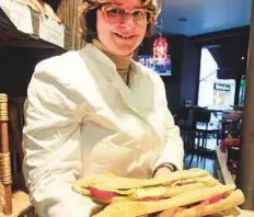  ?? AP ?? ■ Estelle Levy shows sandwiches in her bakery in Paris. Figures revealed that sales of the jambon-beurre sandwich, a classic of French snacking — have been surpassed by sales of burgers.