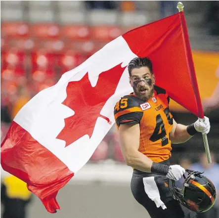  ?? GERRY KAHRMAN/PNG FILES ?? B.C. Lions linebacker Jason Arakgi carries the Canadian flag onto the field prior to a game against the Toronto Argonauts at B.C. Place last season. Arakgi, the CFL’s all-time leader in special teams tackles, announced he’s retiring immediatel­y to...