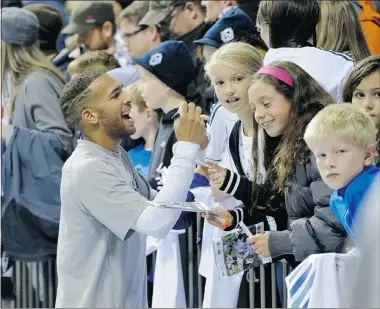  ?? — MARK VAN MANEN/PNG ?? Vancouver Whitecaps midfielder Matt Watson signs autographs for fans last month at BC Place. Will he be back to do the same next year?