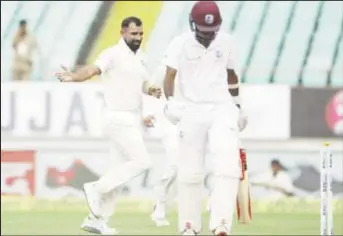  ??  ?? West Indies opener Kraigg Brathwaite walks away after he was bowled by Mohammed Shami on the second day of the opening Test.