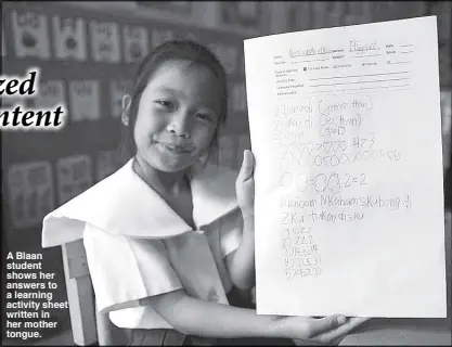  ??  ?? A Blaan student shows her answers to a learning activity sheet written in her mother tongue.