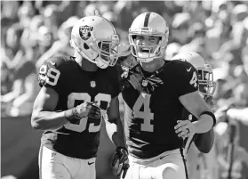  ?? KIM KLEMENT, USA TODAY SPORTS ?? Derek Carr, right, had 513 passing yards, 173 to Amari Cooper.
