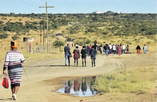  ?? Photo: Deon Ferreira ?? Members of the SA Human Rights Commission walk to school with learners who do not have access to scholar transport, on 6 March. The walk started in Mbizana village, near Middledrif­t, and took them to Ntabenkony­ana Secondary School, nearly 10km away.