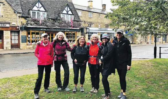  ??  ?? Charlotte Phillips, left, poses with her walking group in Bourton-on-the-Water. The women talked as they walked to learn about each other’s lives before stopping for lunches in local pubs.