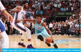  ?? —AFP ?? MIAMI: Jimmy Butler #22 of the Miami Heat drives to the basket against the Philadelph­ia 76ers at American Airlines Arena in Miami, Florida.