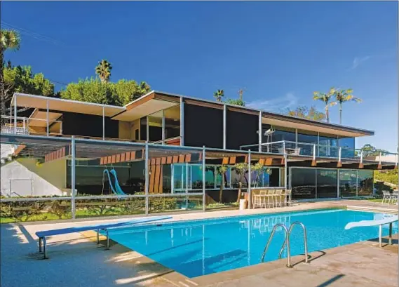  ?? Photograph­s by Cameron Carothers ?? AMONG THE largest Neutra-designed homes in the U.S., this two-story with nautical touches surveys the Port of Los Angeles.