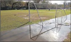  ?? BEN GRAY / AJC ?? Puddles cover soccer fields at the YMCA/Concorde Soccer Complex on Ashford Dunwoody Road on Friday. The fields were unusable because of the water.