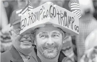  ?? Paul Sancya / Associated Press ?? Charlie Wicka lets his cheesehead prop signal whom he’s supporting Monday in La Crosse, Wis.