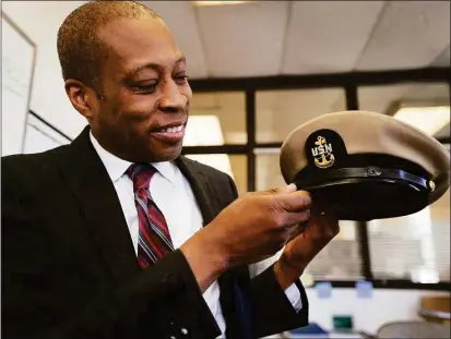  ?? Brian A. Pounds / Hearst Connecticu­t Media ?? Above, West Haven Finance Director Scott Jackson was surprised to acquire his father’s Navy hat from a city resident. Marion “Charles” Jackson was a
career Navy chief petty officer on the aircraft carrier U.S.S. Intrepid.