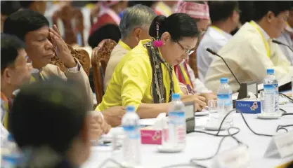  ??  ?? YANGON: Representa­tives of political parties listen to Myanmar’s President Thein Sein’s speech at the Yangon Regional Government Office in Yangon yesterday.—AFP