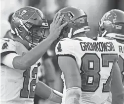  ?? KIM KLEMENT/USA TODAY SPORTS ?? Buccaneers quarterbac­k Tom Brady, left, celebrates with tight end Rob Gronkowski after they connected for a touchdown.