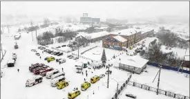  ?? GOVERNOR OF KEMEROVO REGION PRESS OFFICE ?? Ambulances and fire trucks are parked near the Listvyazhn­aya coal mine near the Siberian city of Kemerovo, Russia on Thursday.