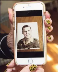  ?? Christian Abraham / Hearst Connecticu­t Media ?? Alfred Andreoli's daughter Patricia Fern shows a photo of her father from his time in the U.S. Army.