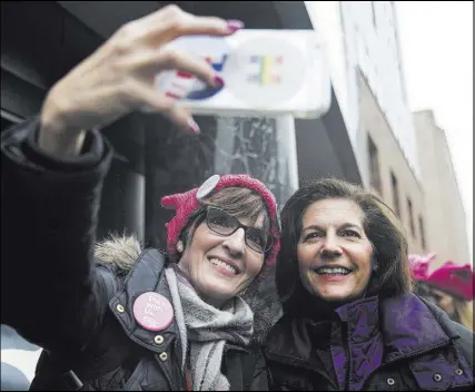  ??  ?? Democratic U.S. Sen. Catherine Cortez Masto of Nevada, right, takes a photo with Carissa Snedeker before walking in the women’s march Saturday in Washington.