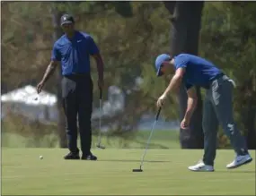  ?? PETE BANNAN — DIGITAL FIRST MEDIA ?? Tiger Woods, left, and Rory McIlroy are among those at Aronimink Golf Club this week for the BMW Championsh­ips.