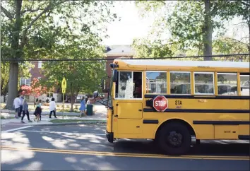  ?? Hearst Connecticu­t Media file photo ?? A school bus picks up students during dismissal at Old Greenwich School in Old Greenwich on Sept. 23.