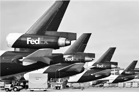  ??  ?? FedEx Corp. cargo planes sit on the tarmac at the company’s distributi­on hub at Los Angeles Internatio­nal Airport. — WP-Bloomberg photos