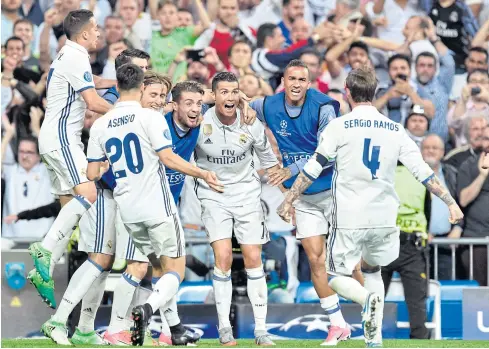  ?? AFP ?? Real Madrid’s Cristiano Ronaldo, third right, celebrates with teammates after scoring against Bayern Munich.
